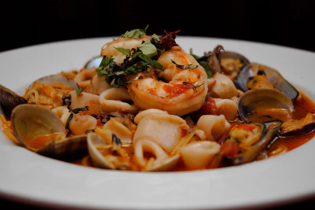 Seafood pasta dish with shrimp, calamari, mussels, clams in red sauce.