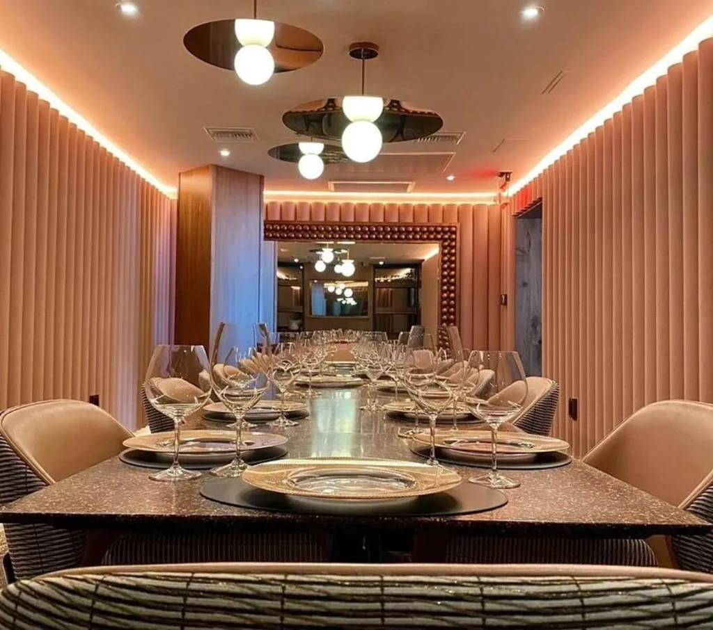 Luxurious modern dining room with a long table set for guests.