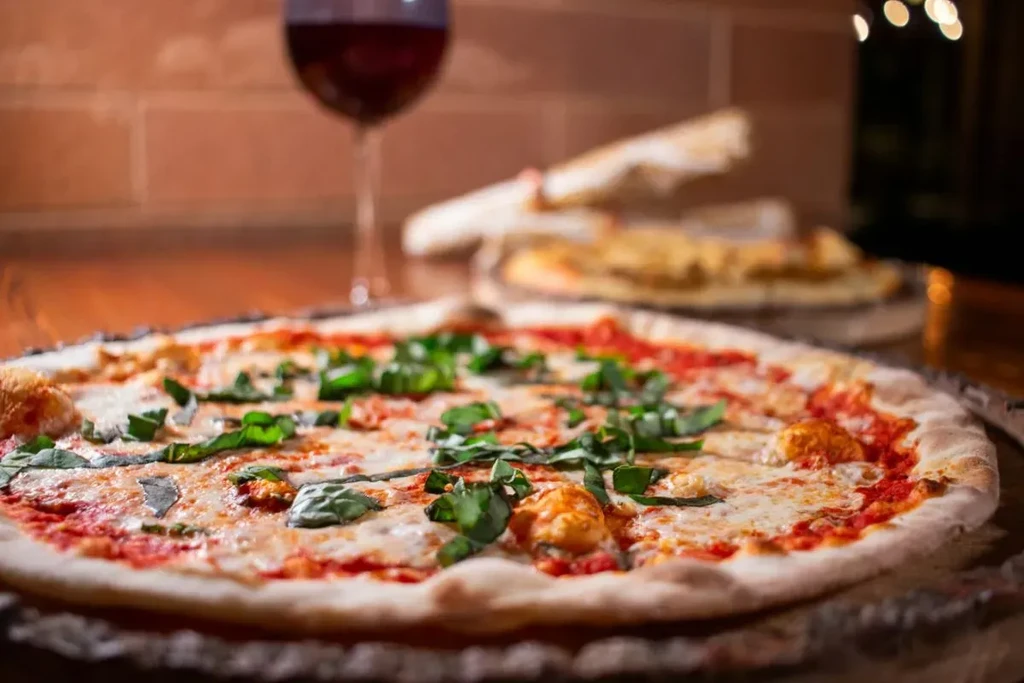 Close-up of Margherita pizza with mozzarella, tomato, basil in a restaurant.