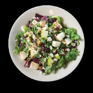 Colorful salad with greens, fruit, crumbled cheese, almonds, dried berries.