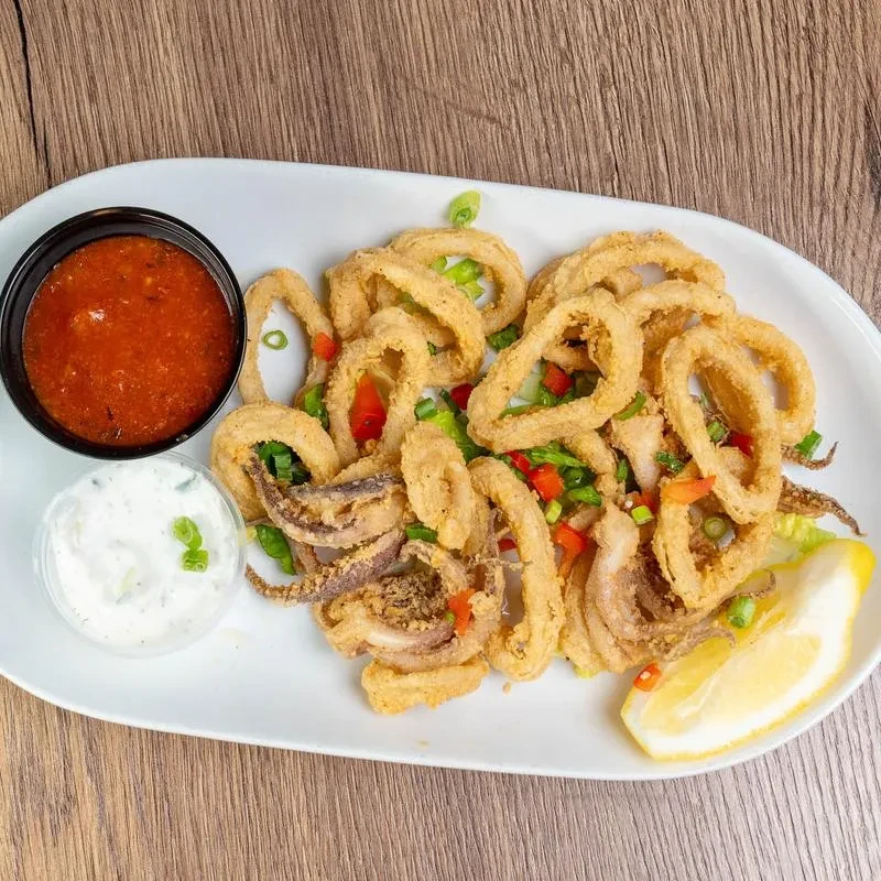 Golden fried calamari, red pepper, green onion, sauces, and lemon wedge.