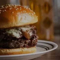 Brioche burger with beef patty, melted blue cheese, caramelized onions.