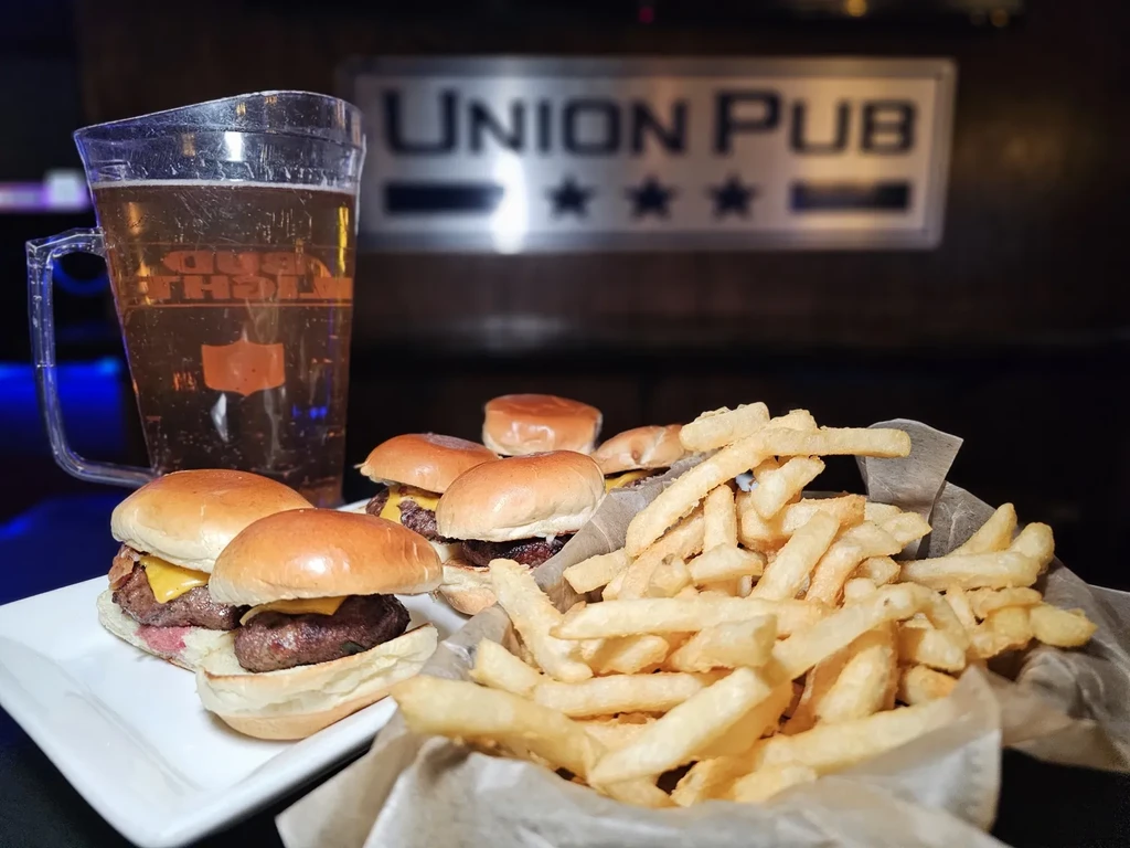 Low-angle shot of sliders, fries, and Bud Light at Union Pub.