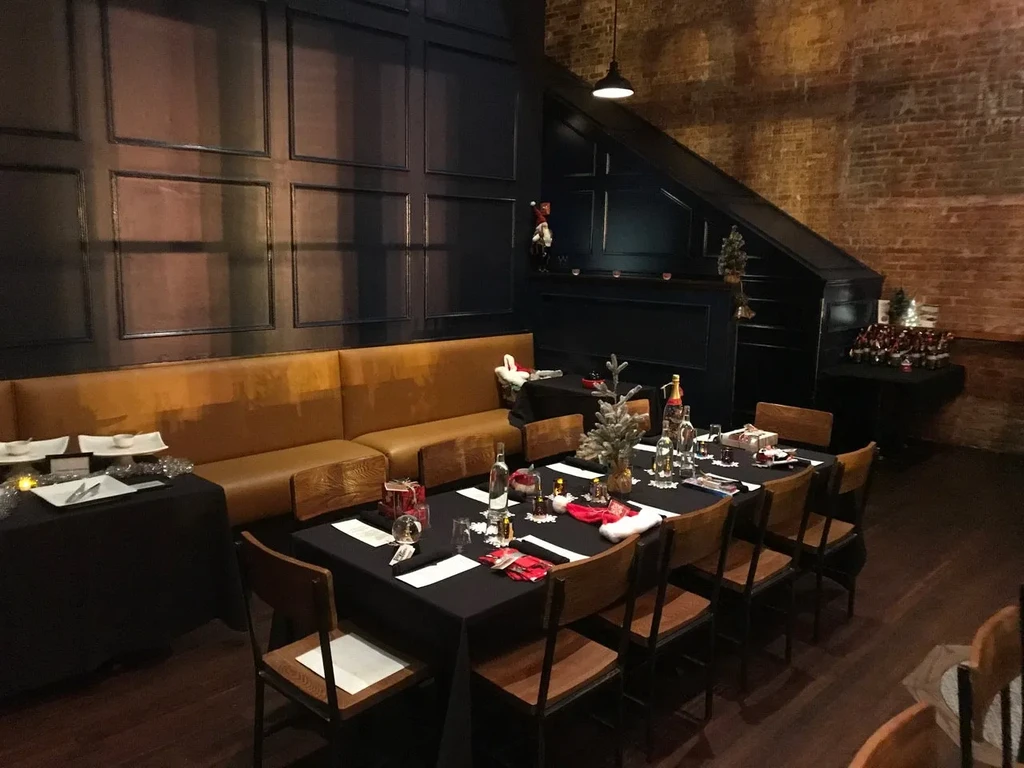 Christmas-decorated restaurant dining area with long table, no people.