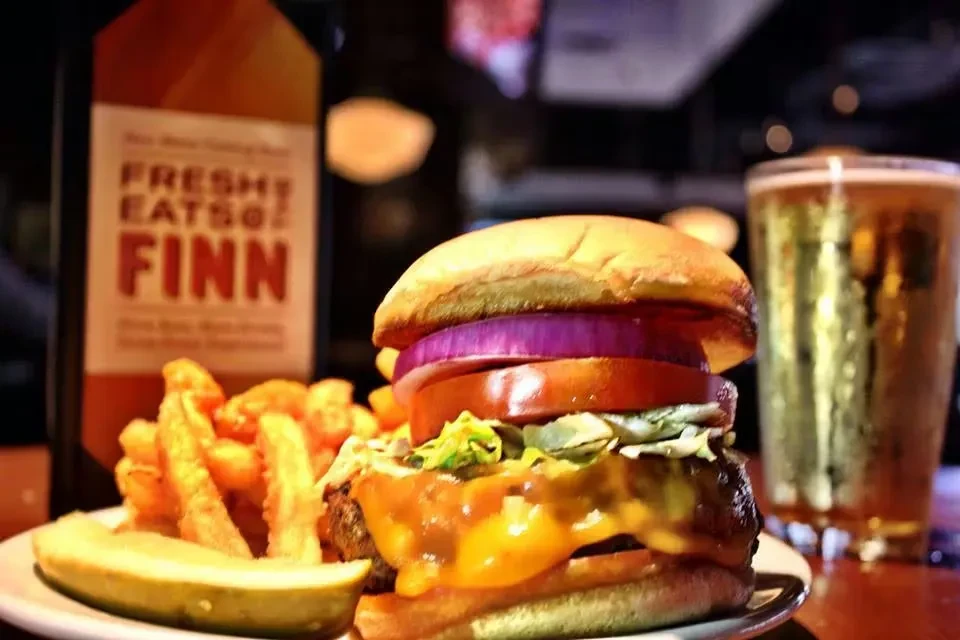 Cheeseburger, crinkle-cut fries, pickle, and a bottle of Fresh Eatso.