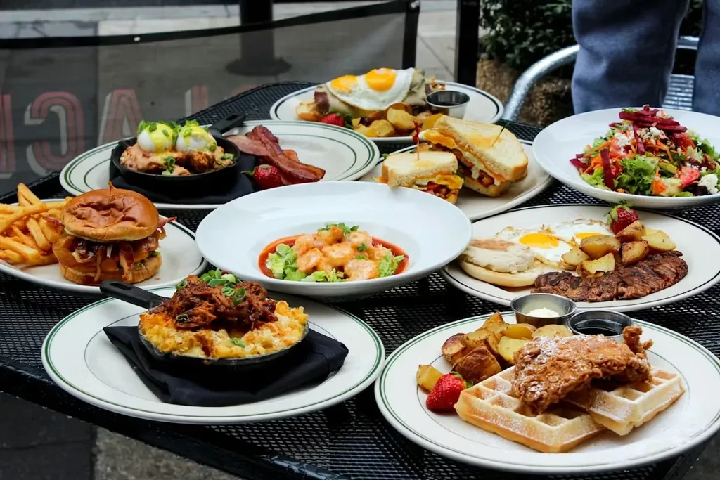 A lavish spread of various brunch dishes on an outdoor table.