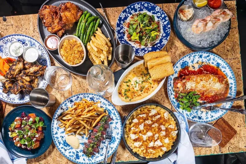Overhead shot of a large, diverse food spread on a rustic table.