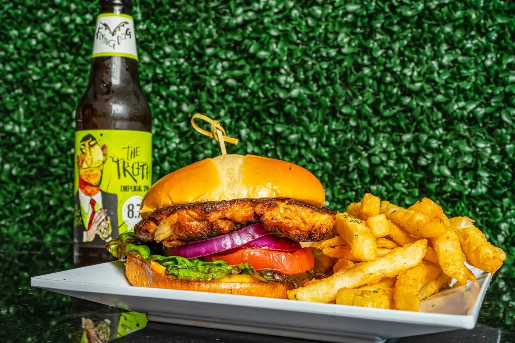 Close-up: gourmet burger, crispy fries, Flying Dog IPA beer.
