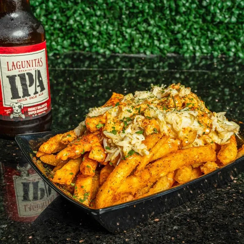 Seasoned fries with shredded seafood, herbs, spices, and Lagunitas IPA beer.