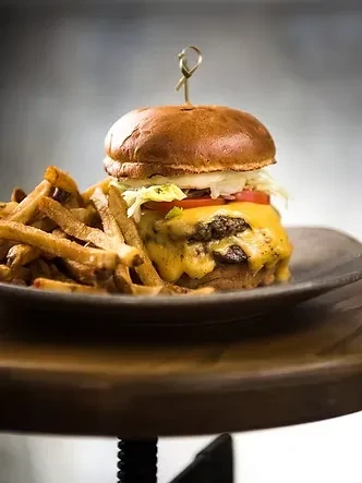 Double cheeseburger with melted cheese, lettuce, and golden french fries.