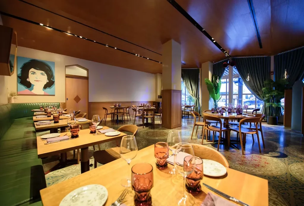 Empty modern restaurant dining room with set tables and pop-art.