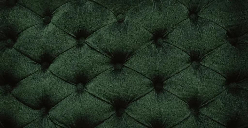 Dark green tufted velvet upholstery with a diamond pattern.