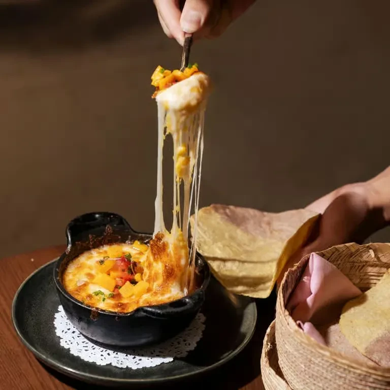 Cheesy, bubbling queso fundido with molten strands and tortillas.