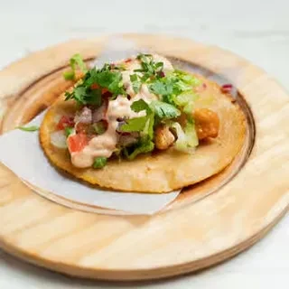 Crispy tortilla topped with lettuce, pico de gallo, fried protein, cilantro.