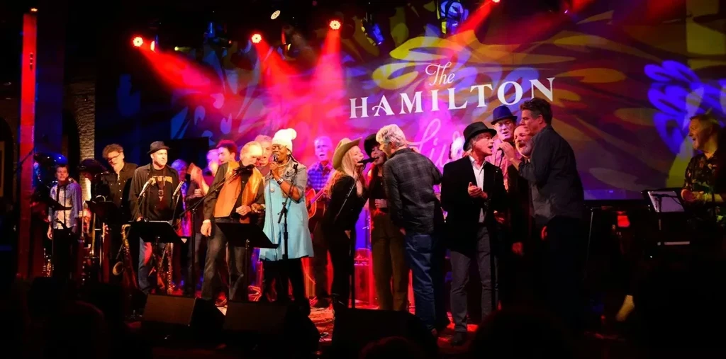 Large group performs live music on stage at The Hamilton Live.