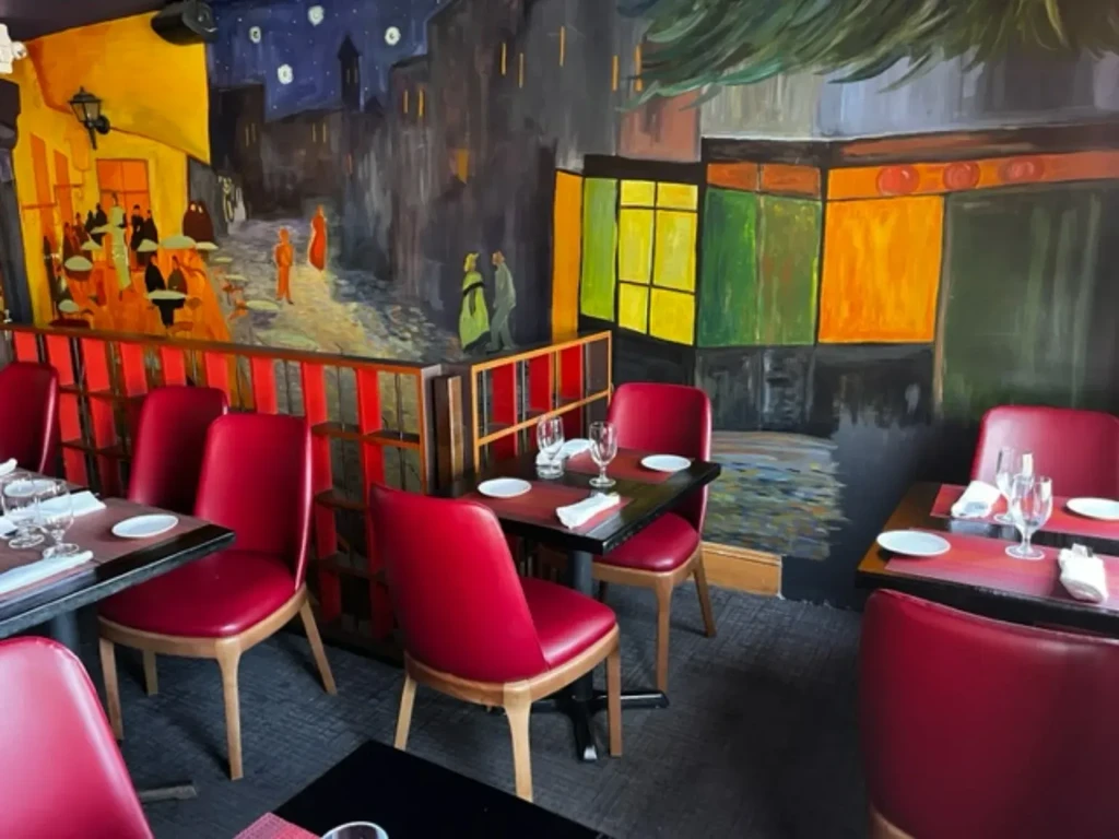Dining area featuring a colorful Van Gogh-style mural and red seating.