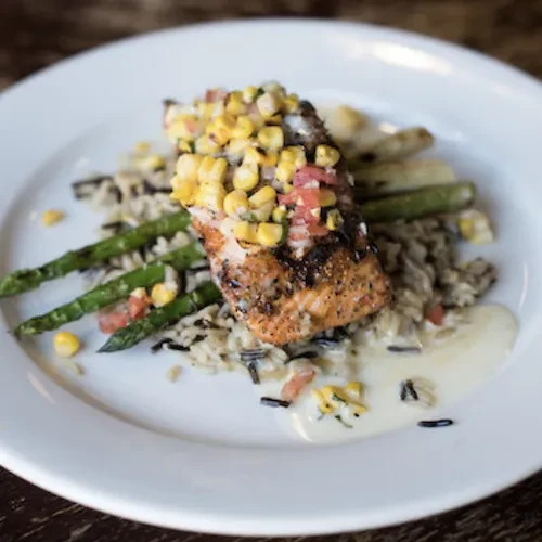 Pan-seared salmon with corn salsa, wild rice, and asparagus.