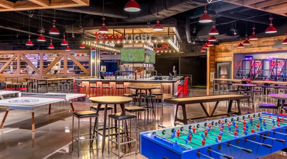 Empty, modern bar and entertainment venue with multiple games.