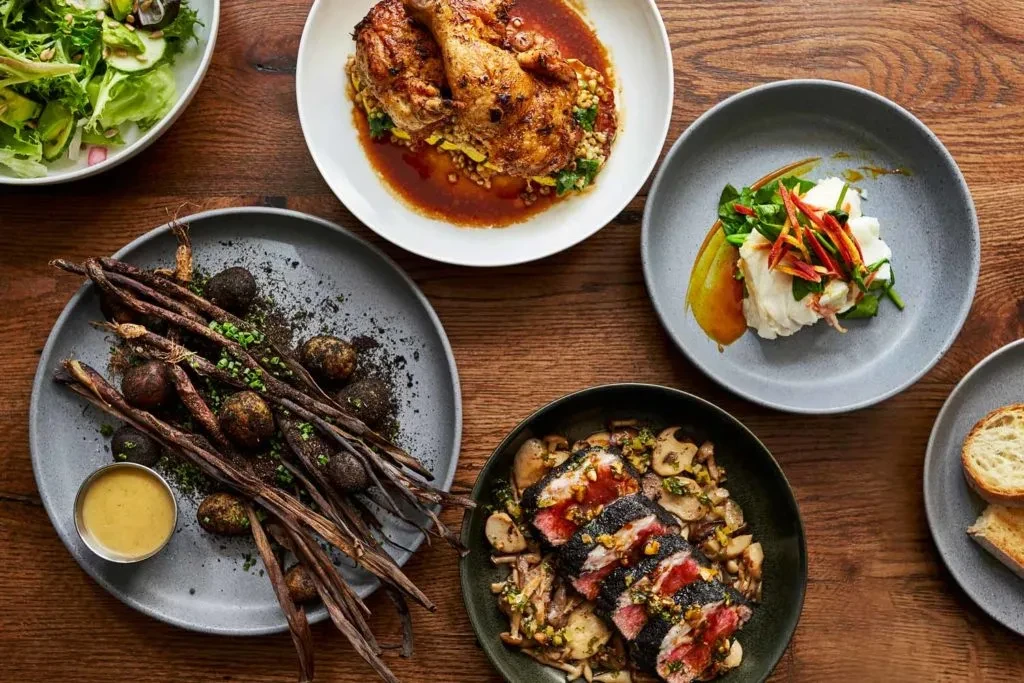 Overhead shot of a beautifully arranged spread of gourmet dishes.