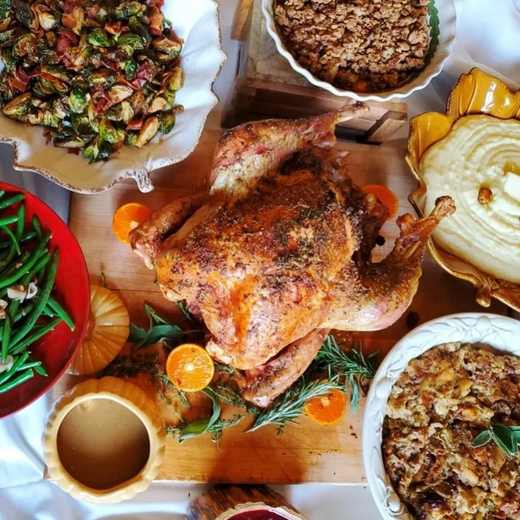Bountiful holiday spread with roasted turkey and many sides.