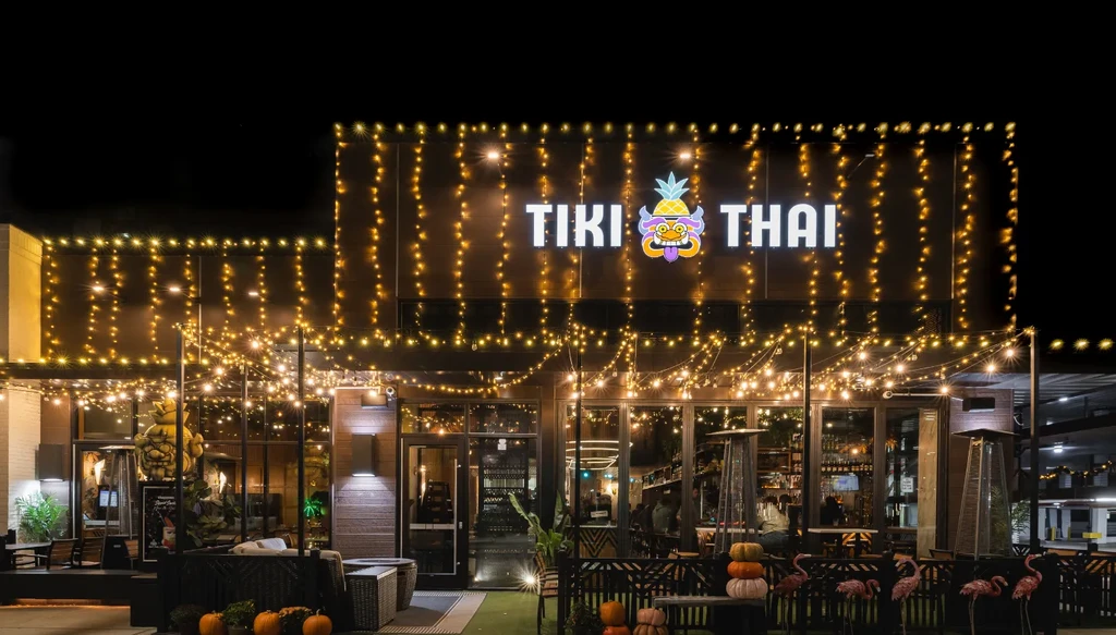Tiki Thai restaurant exterior at night, with bright string lights and patio.