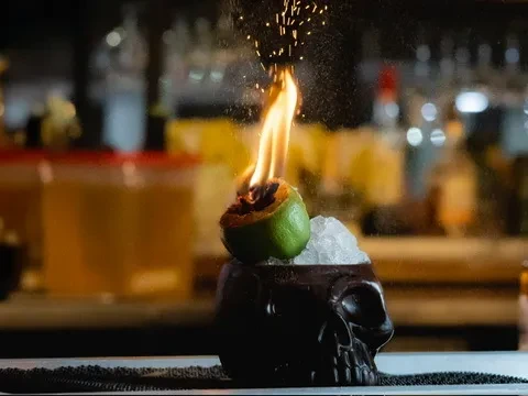 Flaming lime in a dark skull mug with crushed ice.