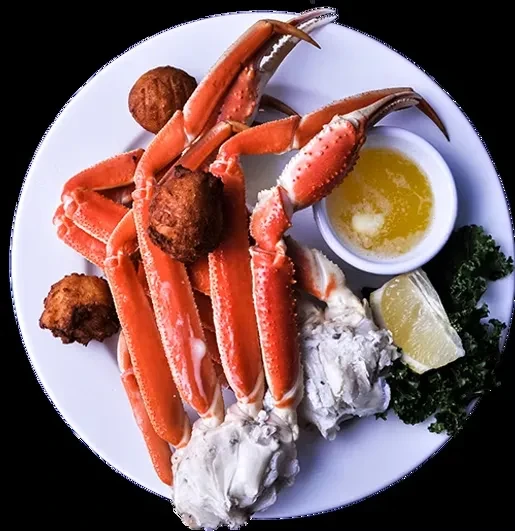 Cooked snow crab legs, hush puppies, lemon, and melted butter.