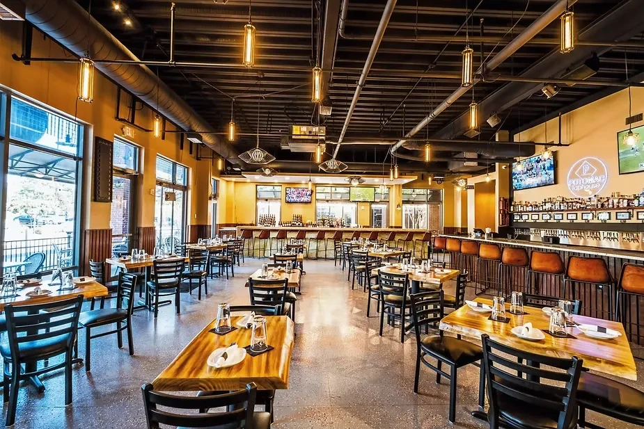 Wide view of Potomac Taphouse interior, industrial style, empty.