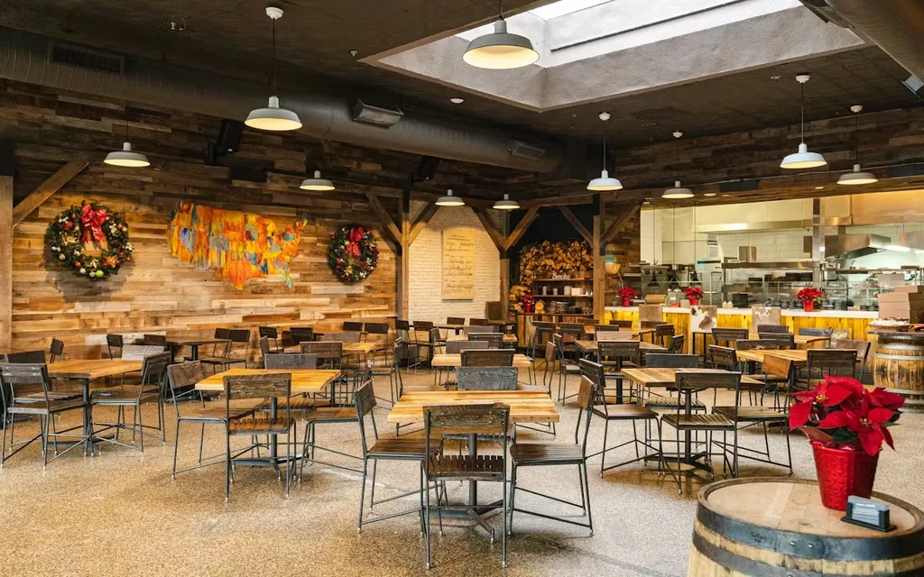 Empty rustic industrial restaurant interior with festive holiday decor.