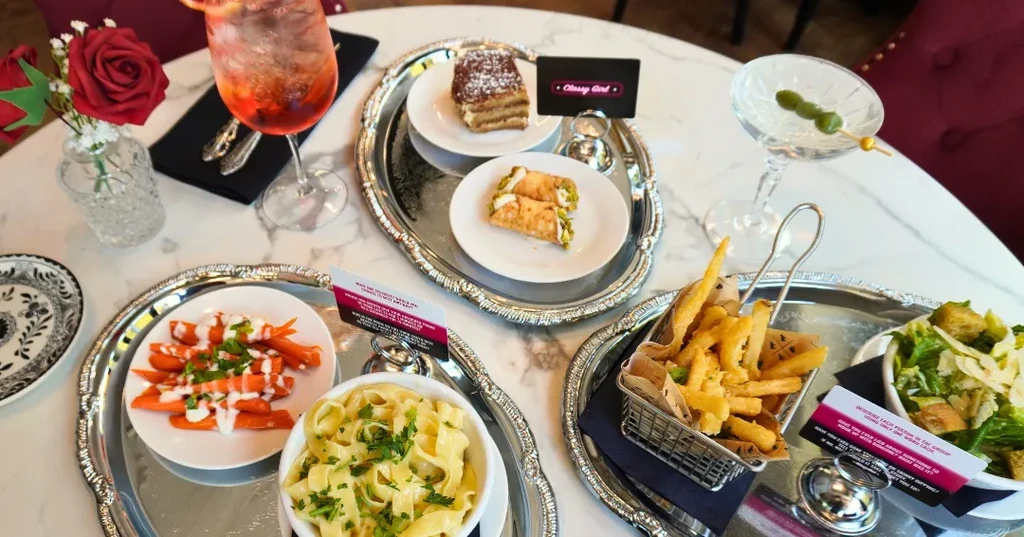 Overhead view of an elegant table filled with diverse dishes and drinks.