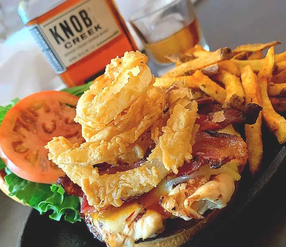 Open-faced burger, onion rings, bacon, fries, Knob Creek bourbon.