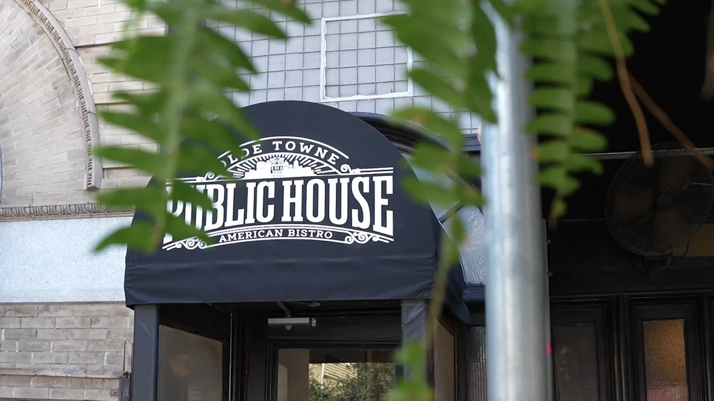 Olde Towne Public House American Bistro entrance with black arched awning.