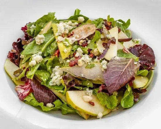 Vibrant gourmet salad with greens, pear, blue cheese, chicken, cranberries.