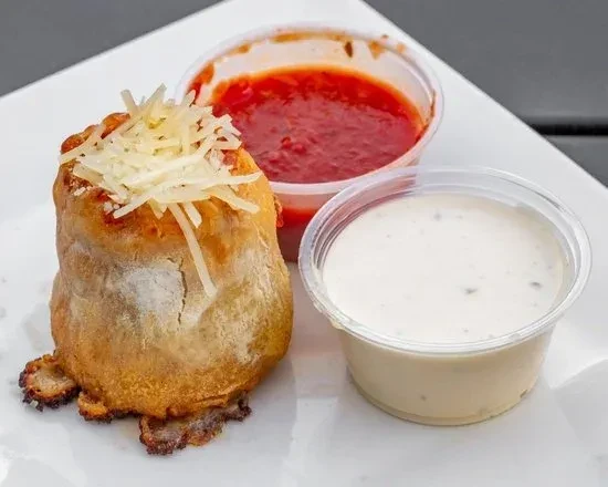 Golden-brown pizza roll with cheese, marinara, and creamy herb sauce.