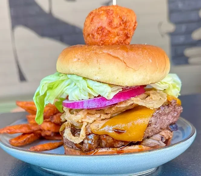 Gourmet beef burger, sweet potato fries, skewered fried sphere.