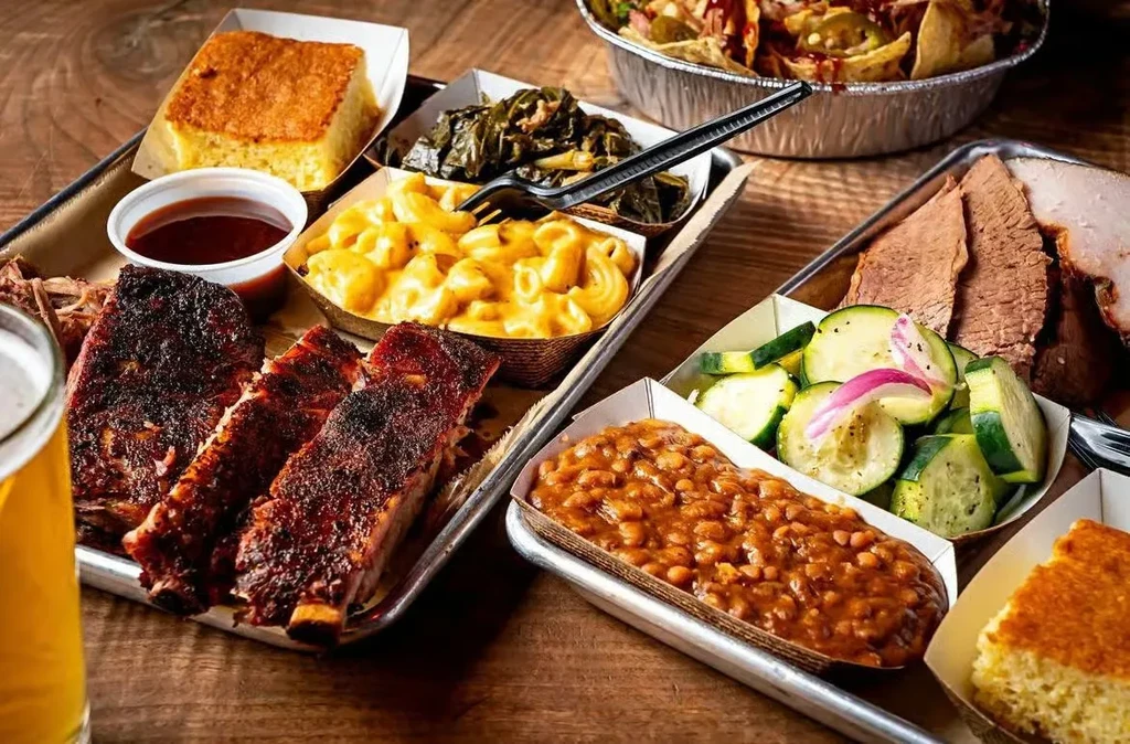 Classic American barbecue spread with ribs, pulled pork, brisket, and sides.