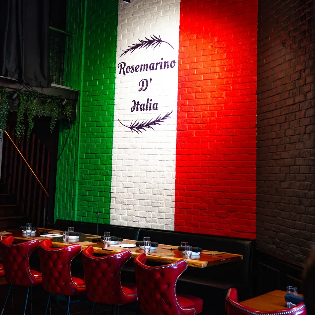 Italian restaurant interior featuring flag wall and "Rosemarino D' Italia."