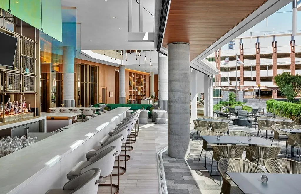 Empty modern restaurant bar and connected outdoor patio.