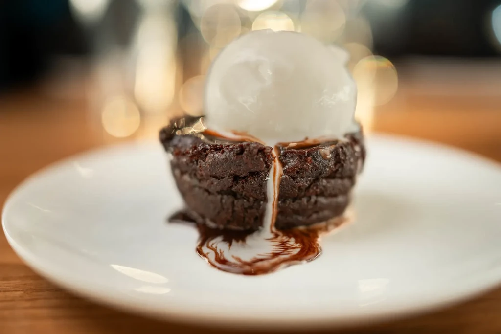 Warm chocolate dessert with ice cream and oozing chocolate sauce.