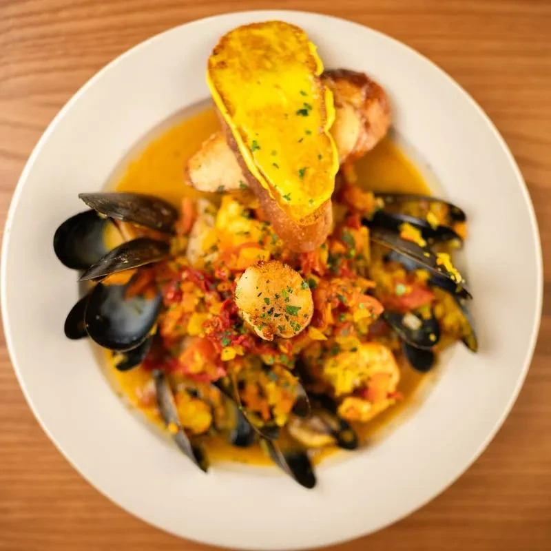 Seafood stew with mussels, shrimp, seared scallop, and toasted bread.