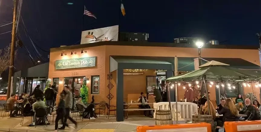The Limerick Dub pub at night, bustling with outdoor patrons.