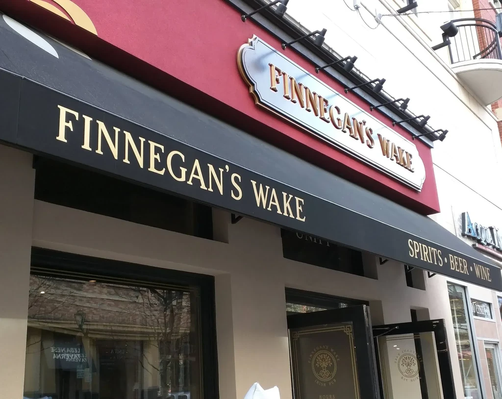 Finnegan's Wake pub exterior with black awning and signage.