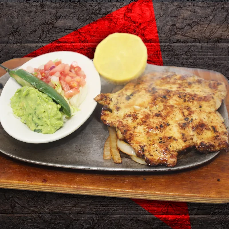 Sizzling chicken fajitas with guacamole, pico de gallo, and lemon.