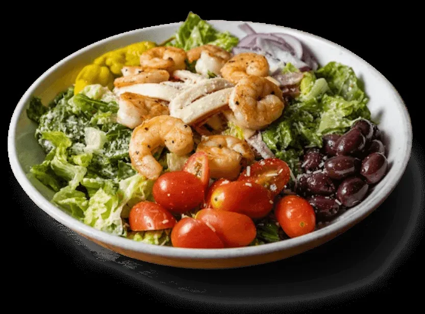 Grilled shrimp and calamari salad with lettuce, tomatoes, olives, and cheese.