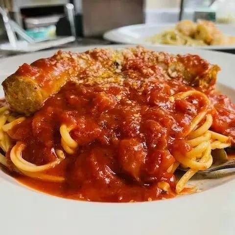 Spaghetti with red marinara sauce, topped with a sauced chicken or sausage.