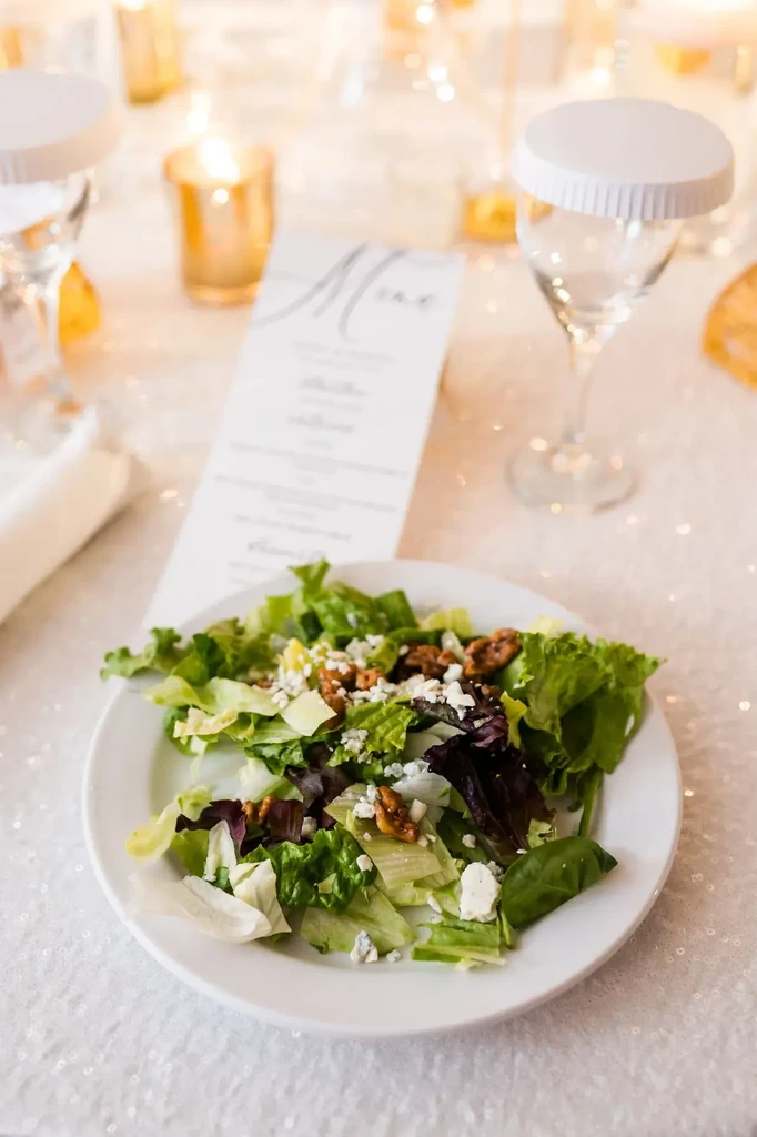 Close-up of a salad with blue cheese, nuts, and lettuce.