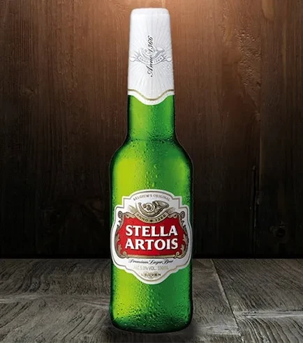 Chilled Stella Artois beer bottle against a rustic wooden background.