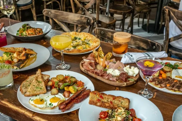 Rustic wooden table laden with various dishes and drinks.