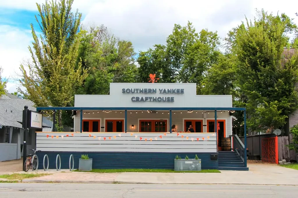 Exterior of Southern Yankee Crafthouse restaurant with a patio and trees.