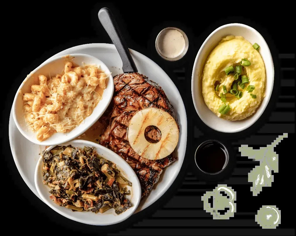 Overhead view of a well-plated steak dinner with sides.